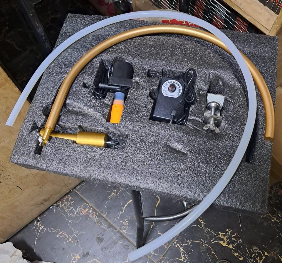 Portable sink shower kit with pump, hose, and fittings.