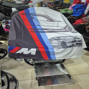 Car-striped barber shaving gown with adjustable neckline for secure fit and client protection.
