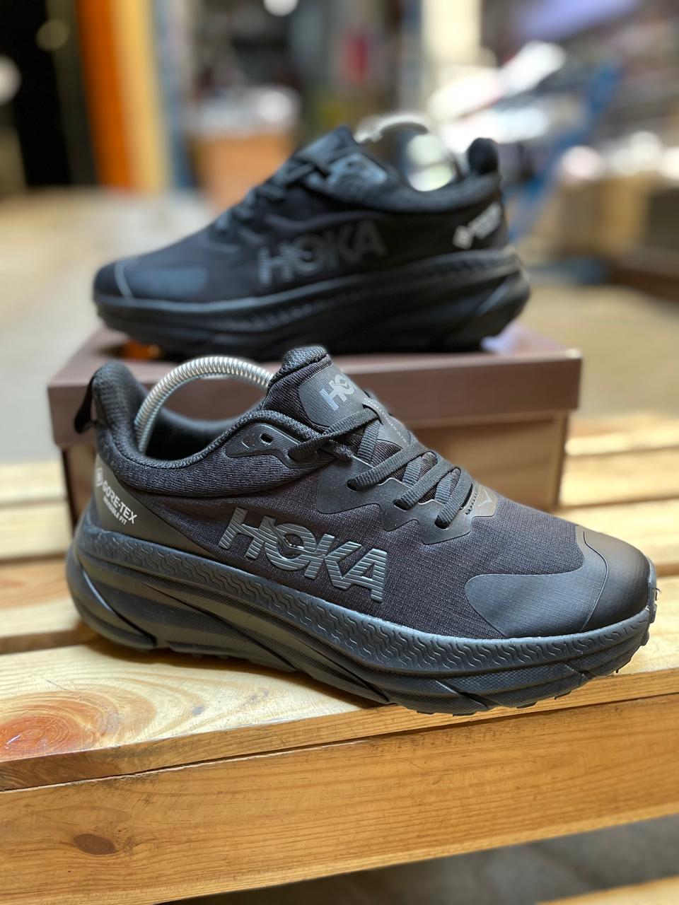 Hoka unisex running shoes in black and grey, lightweight and cushioned.