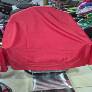 Diamond-patterned barber shaving gown for comfort and protection.