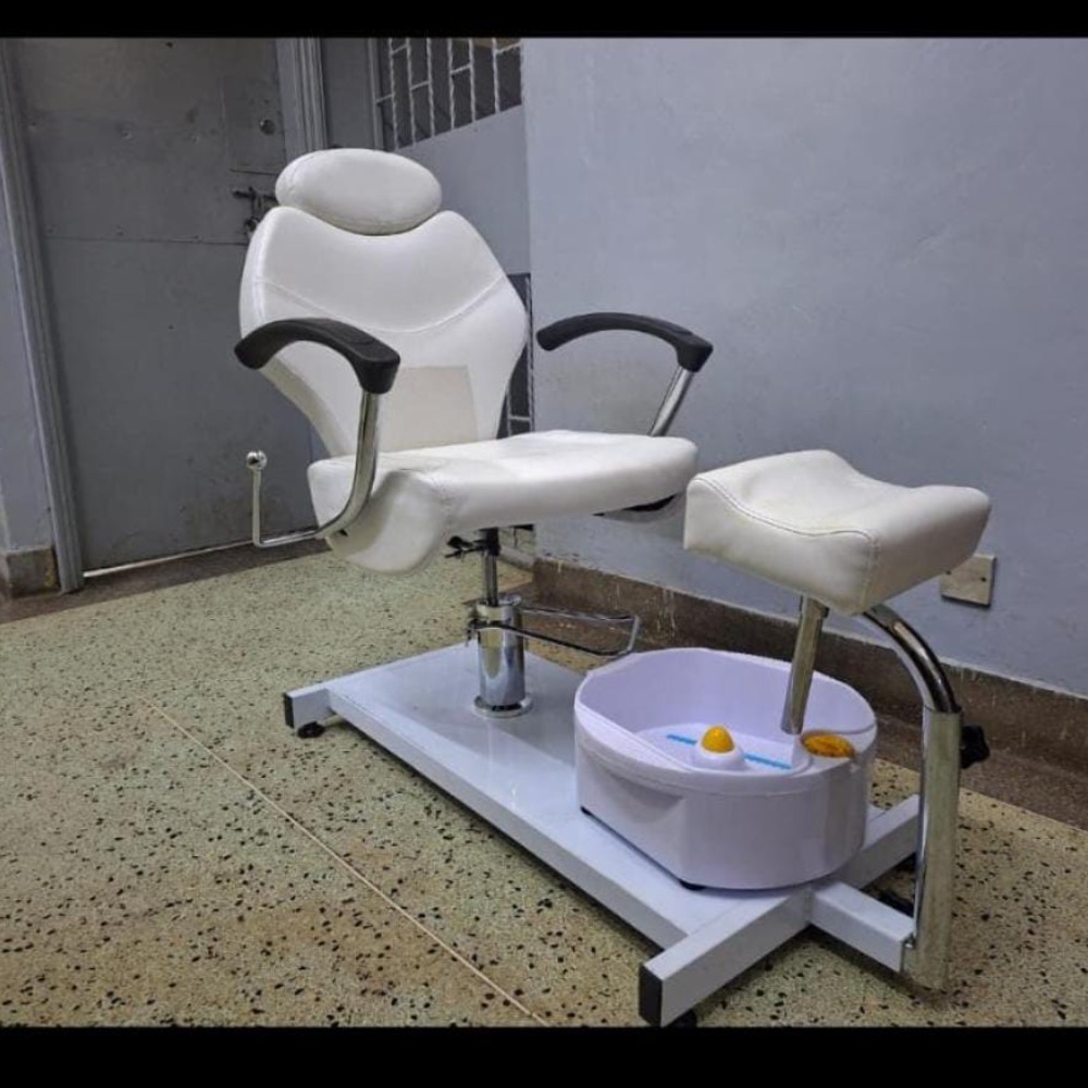 Pedicure chair with matching adjustable footrest for salon and spa use.