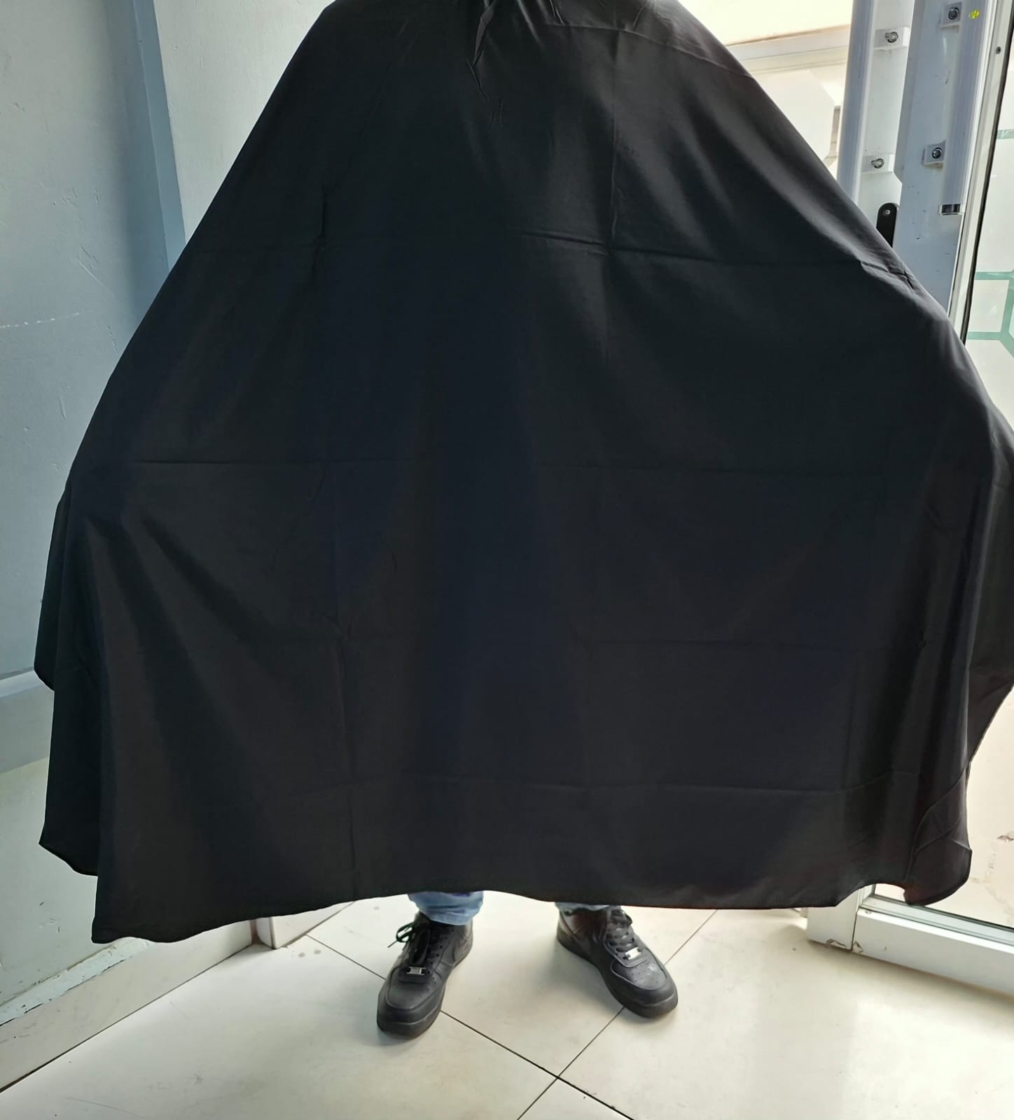 Diamond-patterned barber shaving gown for comfort and protection.