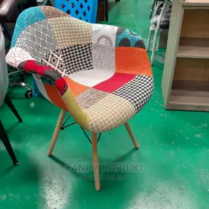 Salon manicure seat with African print fabric and armrests, offering comfort and style for beauty treatments.